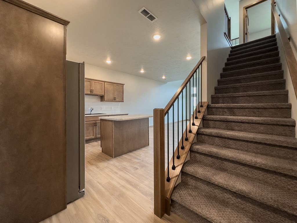 a staircase leading up to a kitchen in a home with stairs