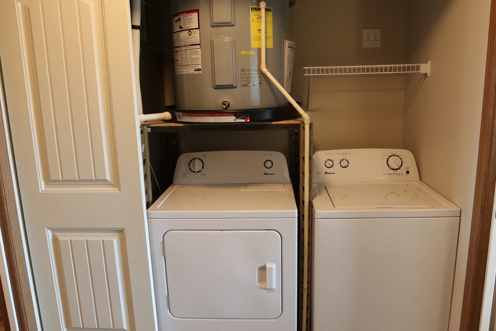 the laundry room has a washer and dryer and a refrigerator