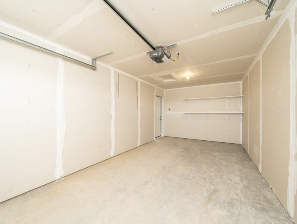an empty room with a ceiling fan in it