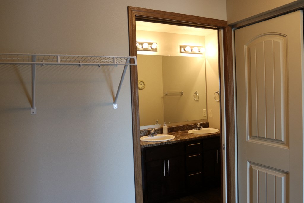 a bathroom with two sinks and a large mirror