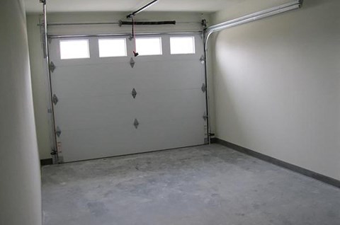 a white garage door with three windows in it