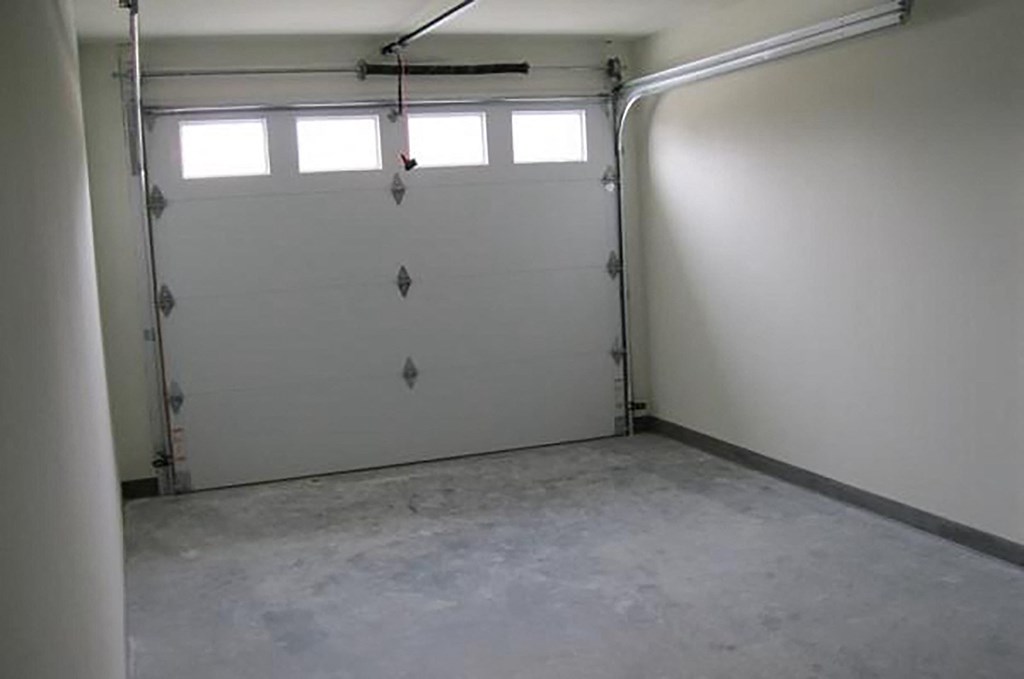 a white garage door with three windows in it