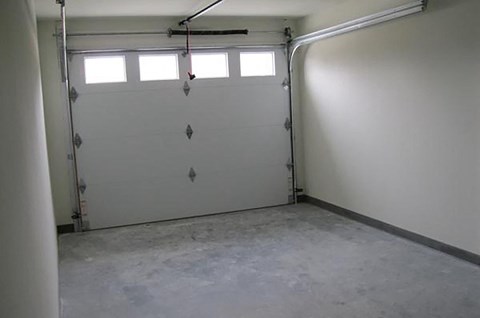 a white garage door with three windows in it