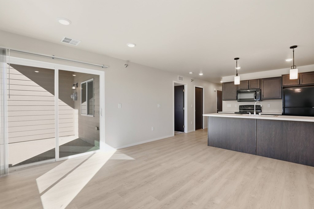 A modern kitchen with a white countertop and dark cabinets.