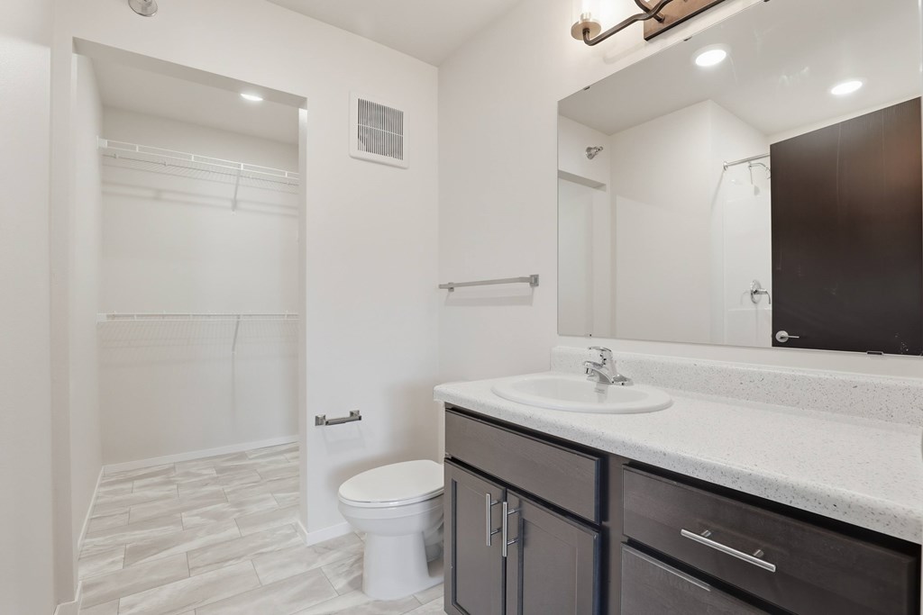 A bathroom with a white toilet and a white sink.