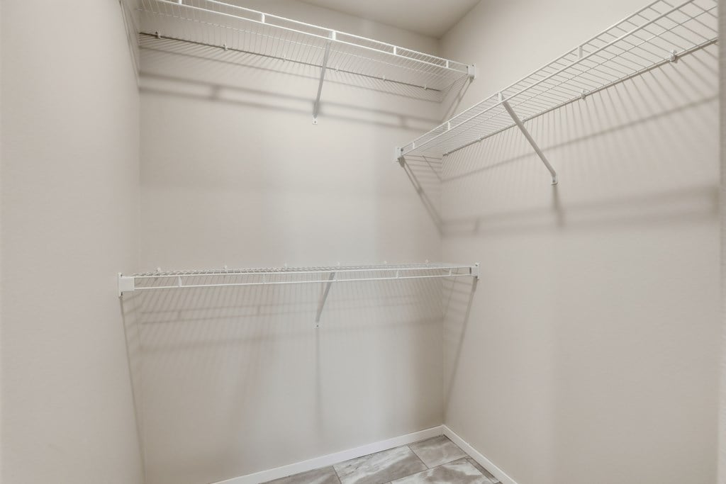 Empty white shelves in a room.