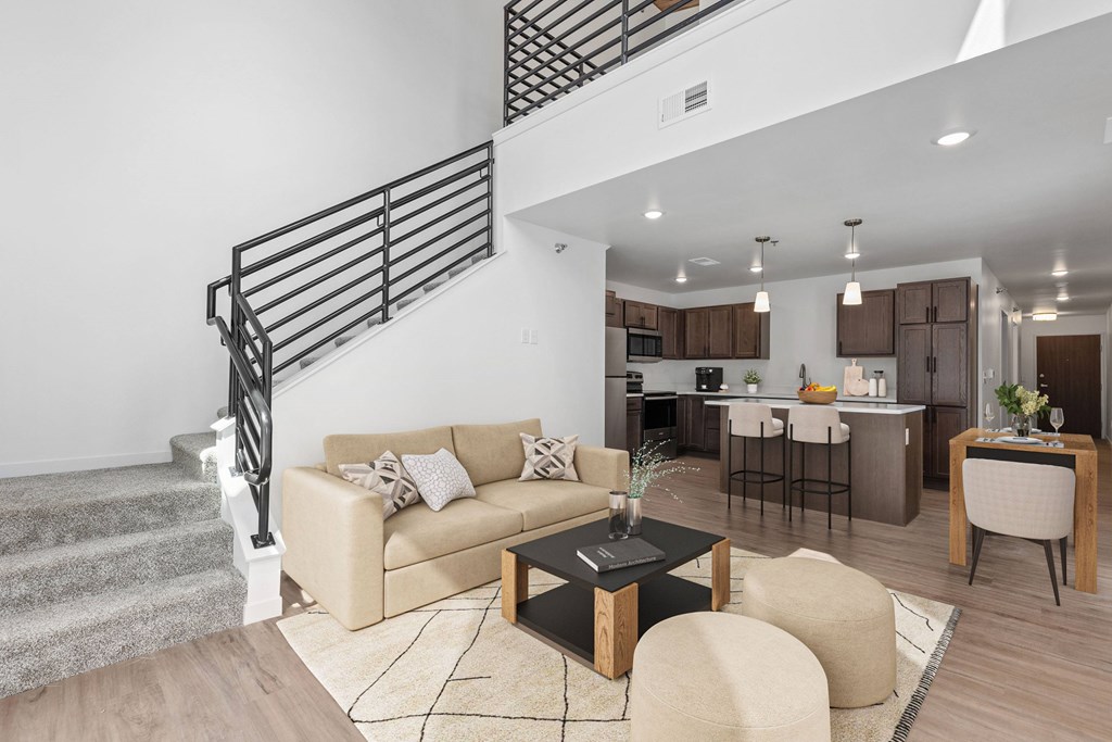 A living room with a staircase and a couch.