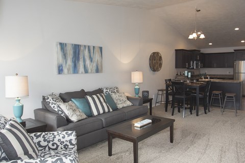 a living room and dining room with a couch and a table