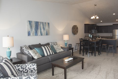 a living room and dining room with a couch and a table