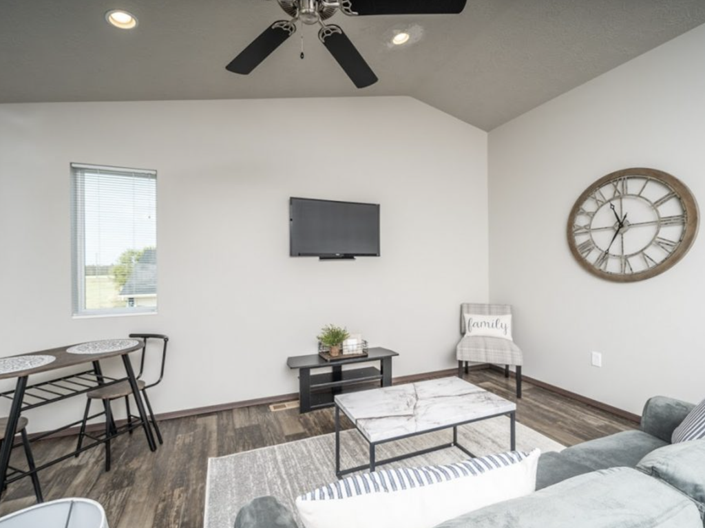 a living room with a large clock on the wall