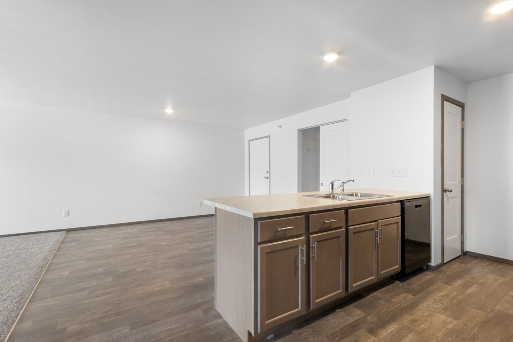 A kitchen with brown cabinets and a white countertop.