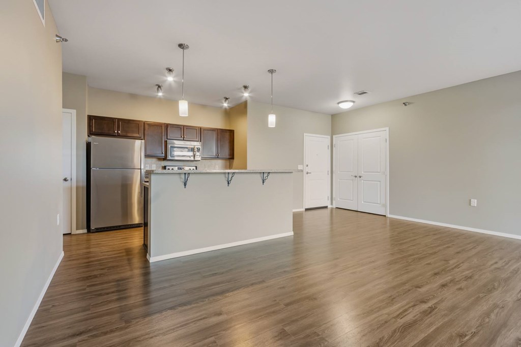 A kitchen with wooden floors and white walls.