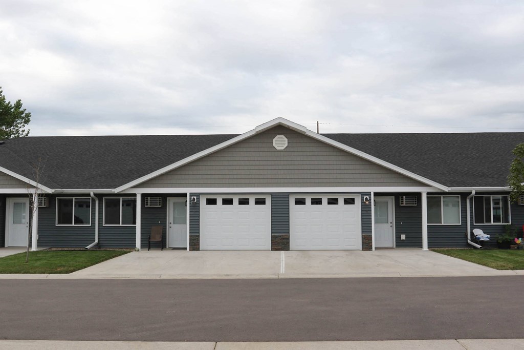 the front of a house with two garage doors