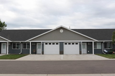 the front of a house with two garage doors