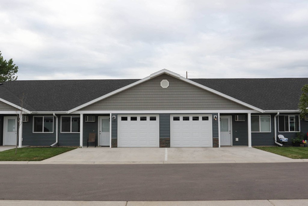 the front of a house with two garage doors