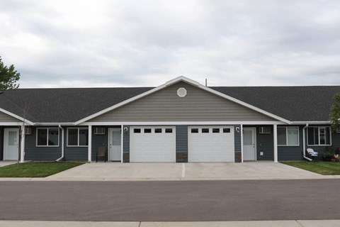 the front of a house with two garage doors