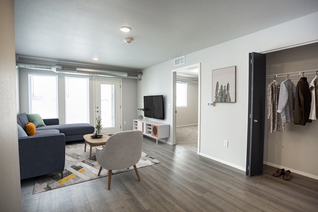 a living room with a couch and a chair and a tv