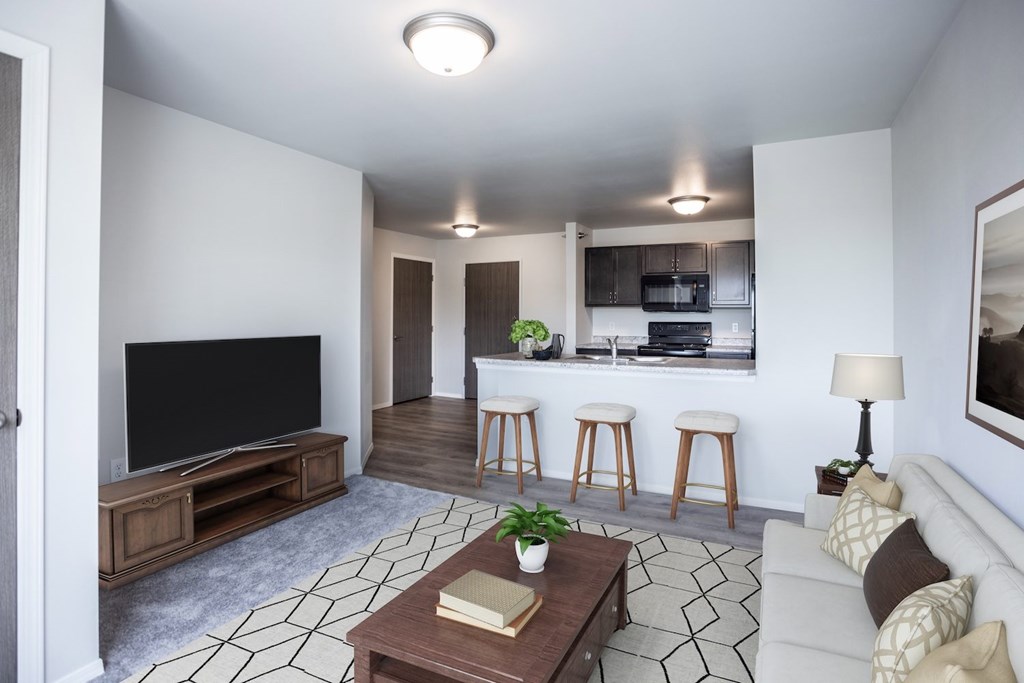 A living room with a television, a couch, and a coffee table.