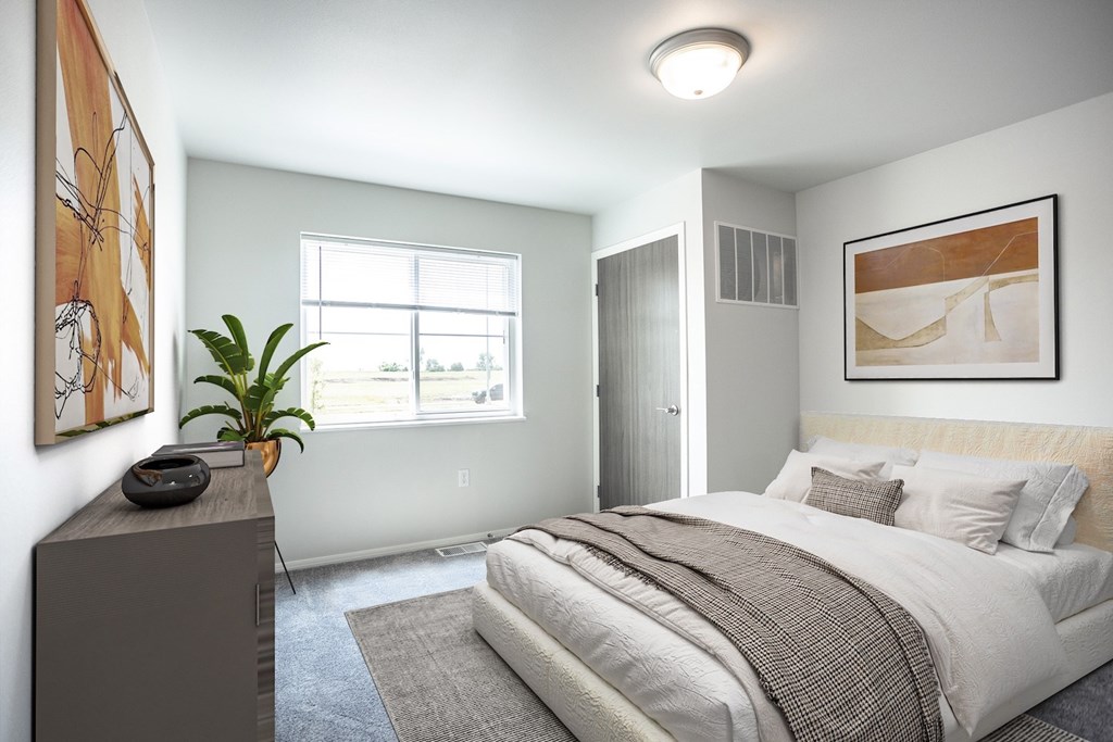 A bedroom with a large bed and a painting on the wall.