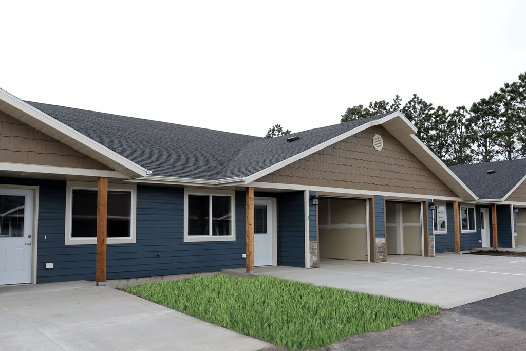 a blue house with a porch and a driveway