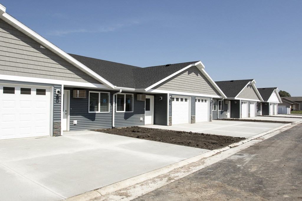a row of houses with a driveway in front of them