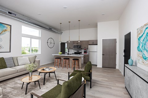 A living room with a couch, chairs, and a dining table.