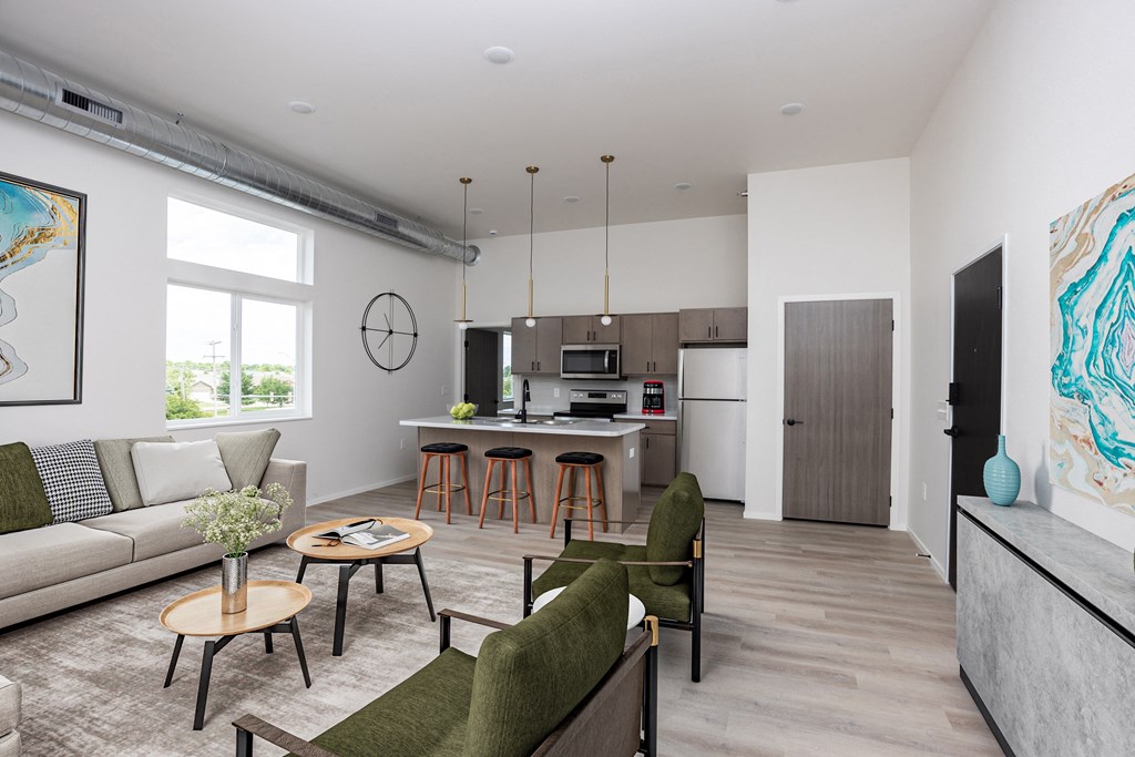 a living room with a couch and a kitchen with a