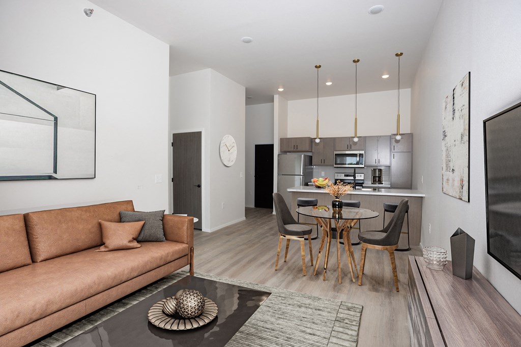 a living room with a couch and a table with chairs