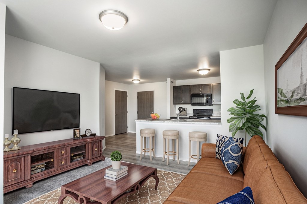 A living room with a brown couch and a flat screen TV.