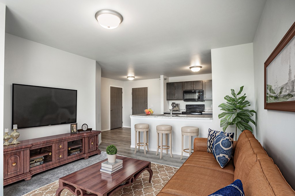 A living room with a brown couch and a flat screen TV.