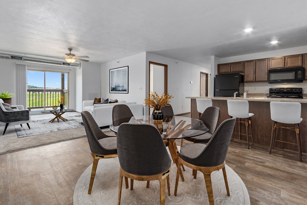 A modern dining room with a glass table and chairs.