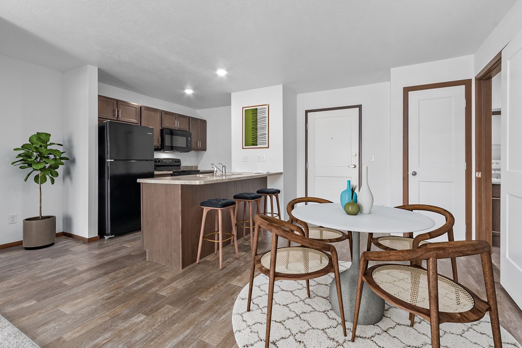A kitchen with a table and chairs in the middle of the room.