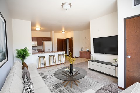 A living room with a white couch and a black coffee table.