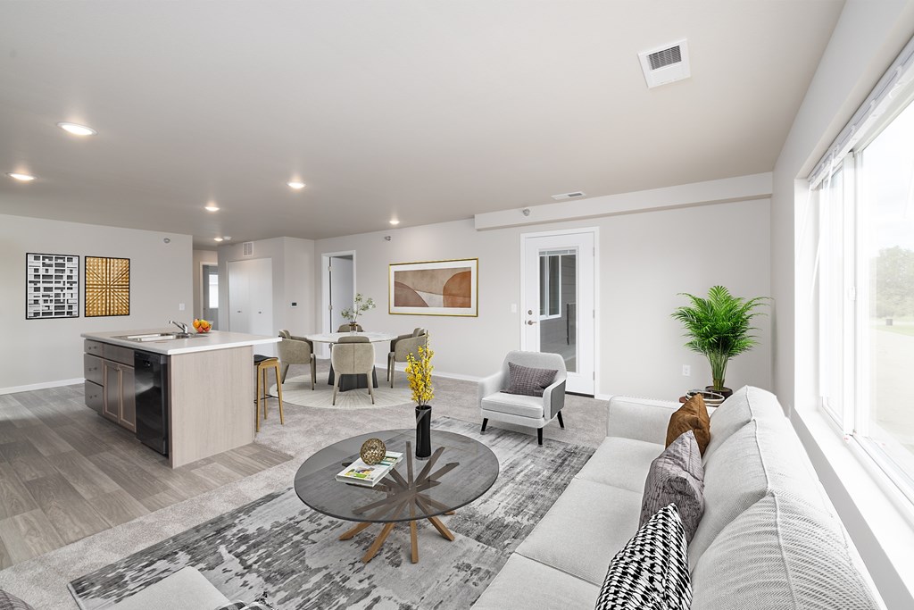 A modern living room with a grey sofa and a coffee table.