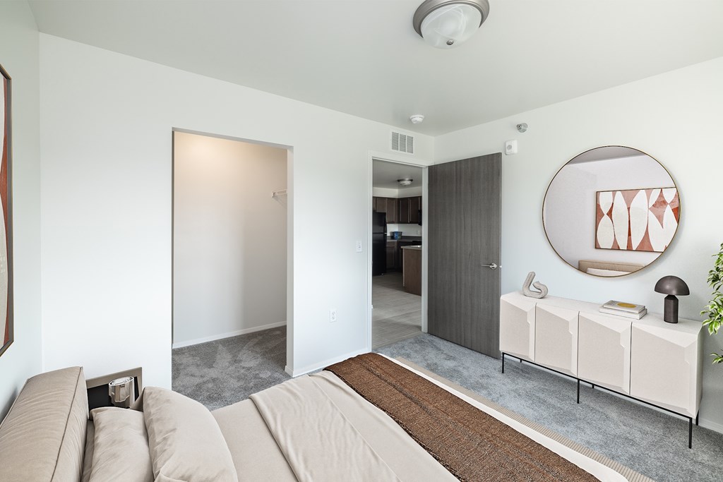 A living room with a couch and a mirror on the wall.