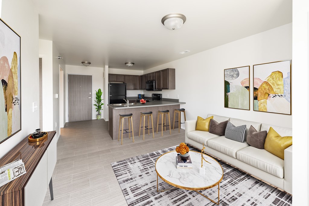 A living room with a white couch and a coffee table.