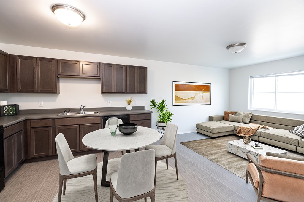 A modern kitchen with a dining table and chairs.