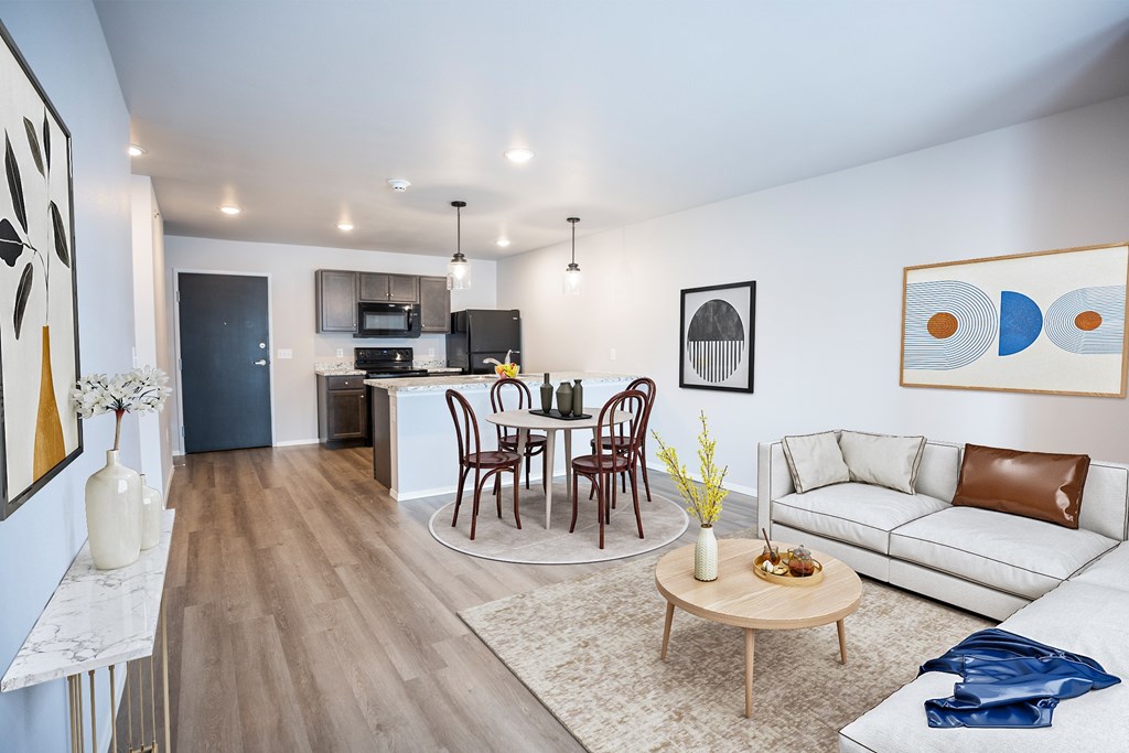A modern living room with a dining table set up in the middle.