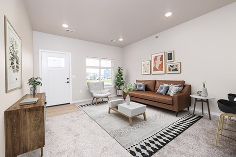 A living room with a brown couch, a coffee table, and a chair.