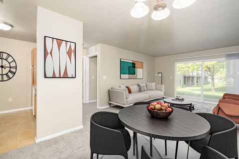 A modern dining room with a round table and chairs.