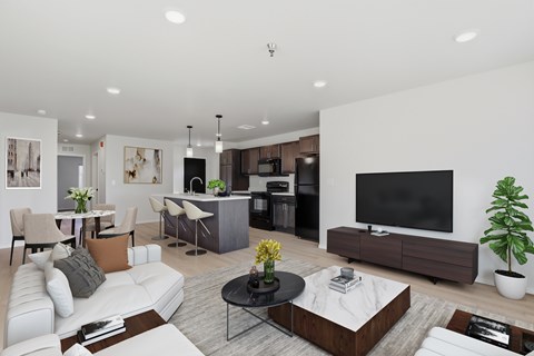 A modern living room with a white sofa, a black coffee table, and a flat-screen TV.