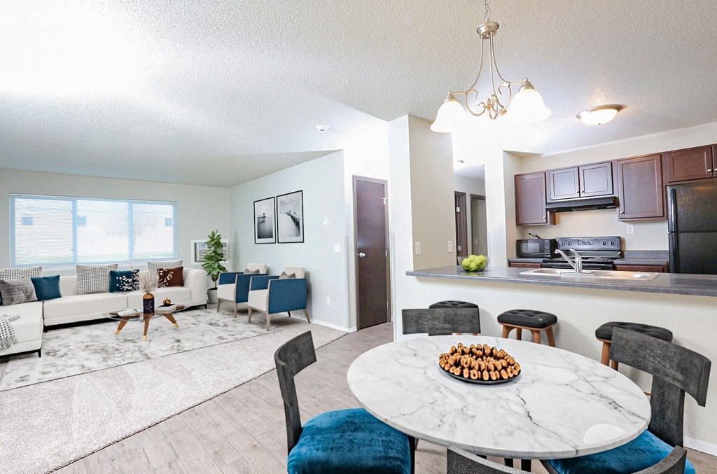 A modern living room with a dining table set for two.