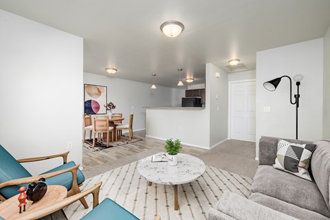 A living room with a grey couch and a white coffee table.