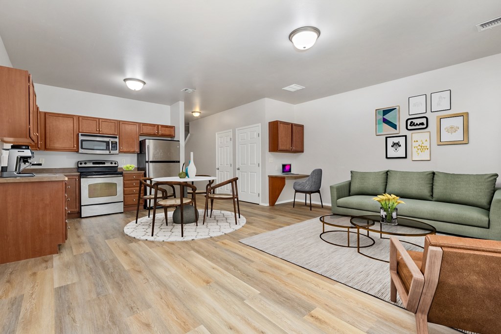 A kitchen with a dining table and chairs in the middle of the room.