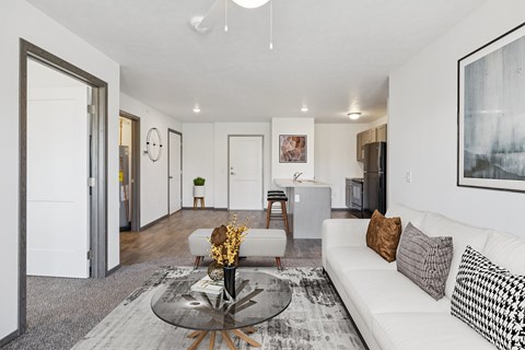 A modern living room with a white sofa and a glass coffee table.