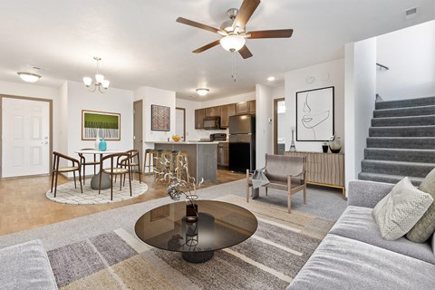 A modern living room with a grey sofa and a glass coffee table.
