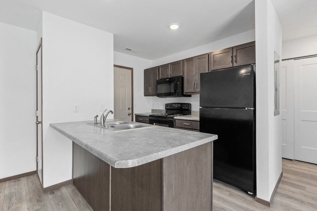 a kitchen with a sink and a refrigerator