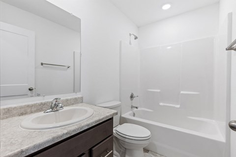a bathroom with a sink toilet and a shower