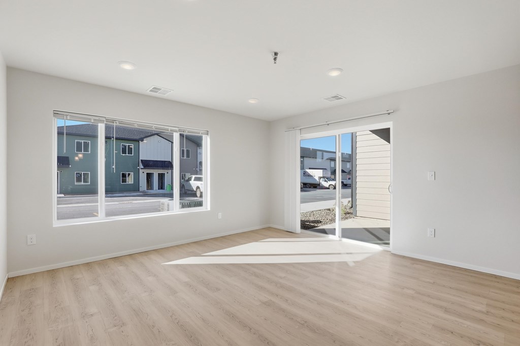 A large empty room with a view of the street outside.