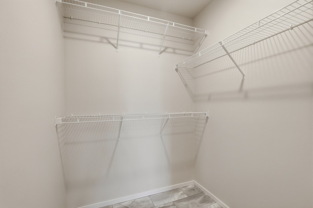 Empty white shelves in a room.